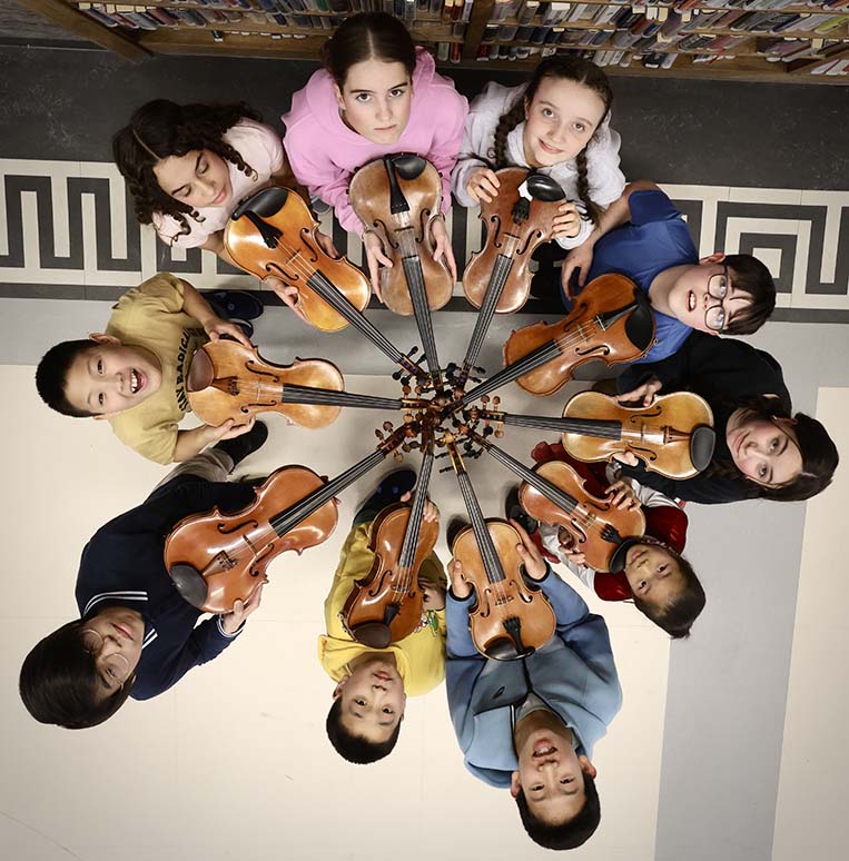 This is a photo showing 10 violinits with their instrument